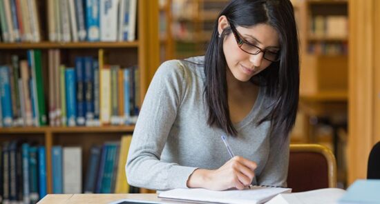 Black-haired woman studying in the library