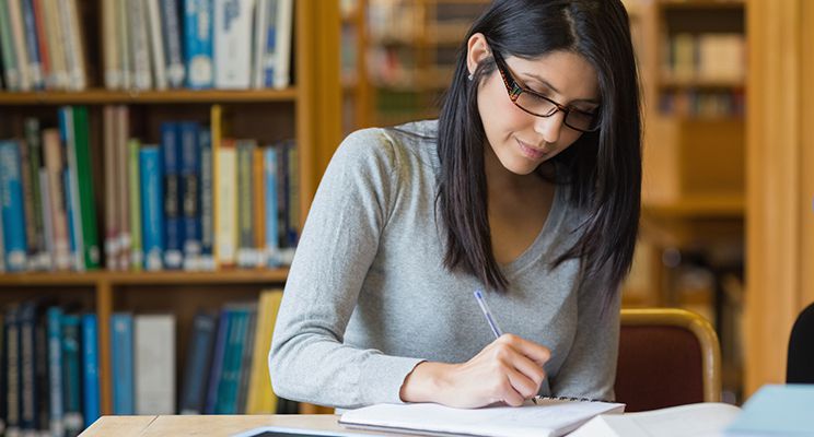 Black-haired woman studying in the library