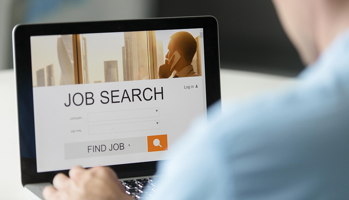 Monitor view over a male shoulder, job search title